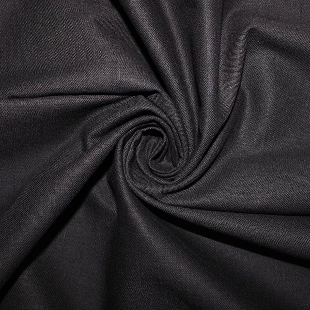 A close-up of black fabric arranged in a spiral drape, showing its smooth texture and subtle sheen.