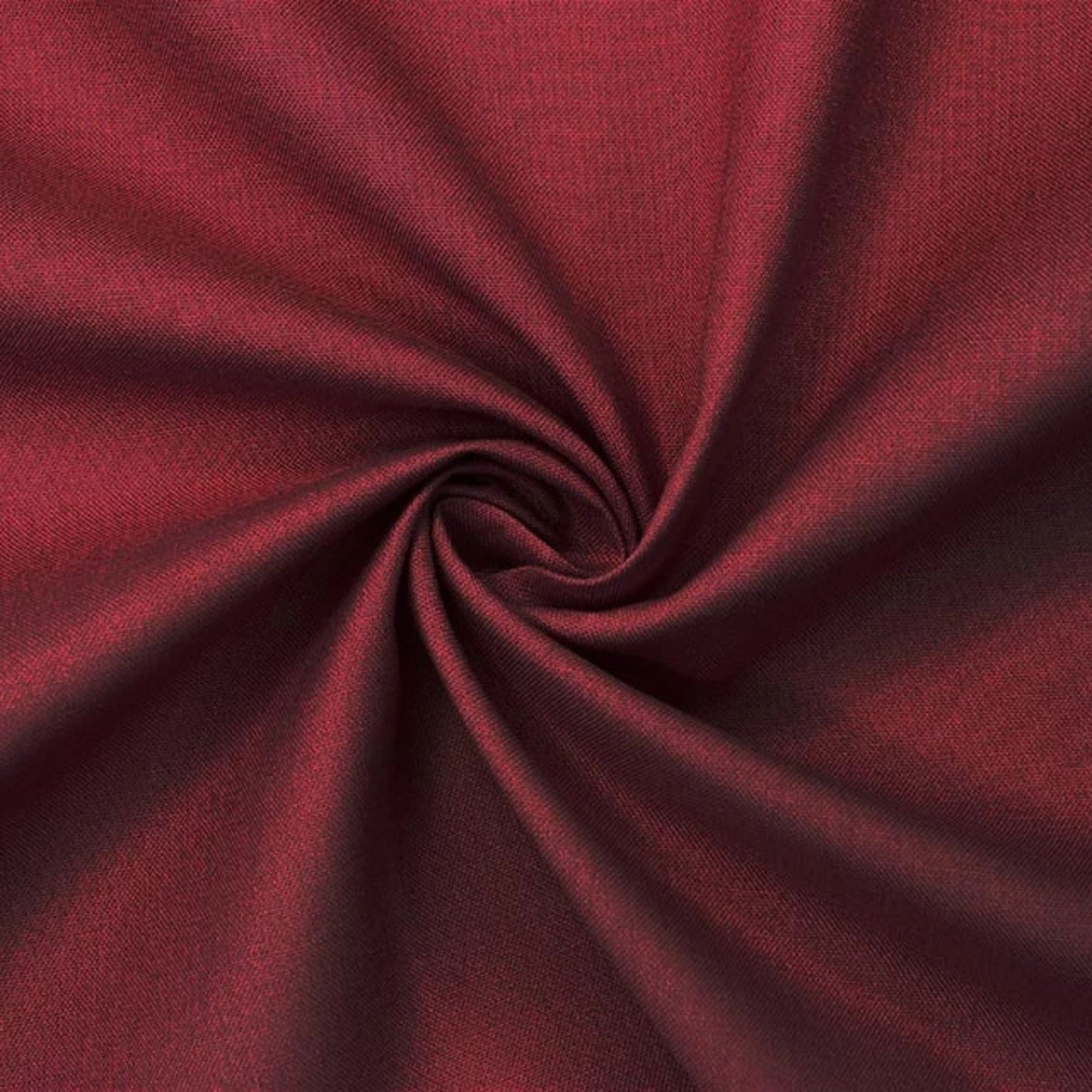 A close-up of deep burgundy fabric arranged in a spiral swirl, showing the material texture and color.