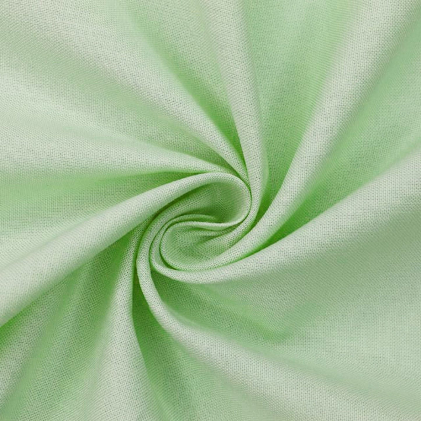 A close-up of light mint green fabric arranged in a spiral drape, showing the material texture and color.