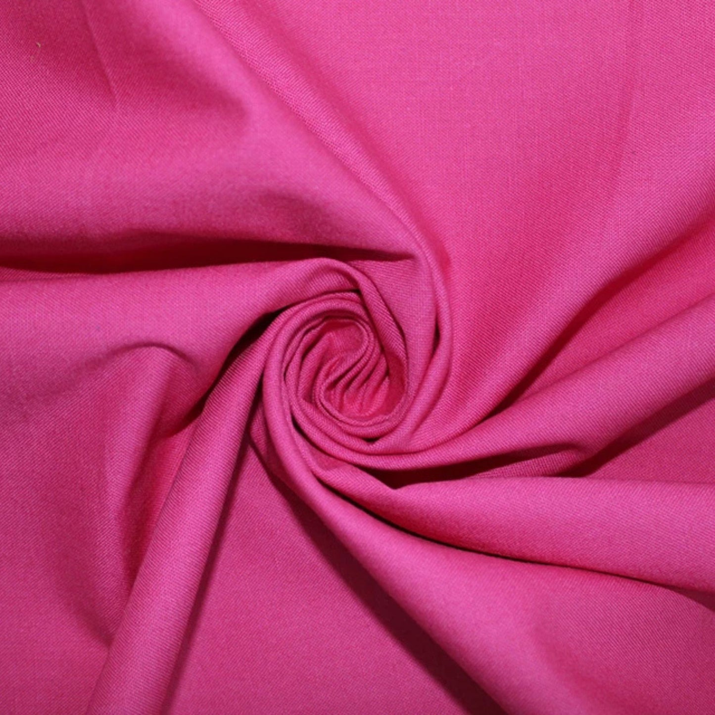 A close-up of bright pink fabric arranged in a spiral drape, showing the material texture and color.