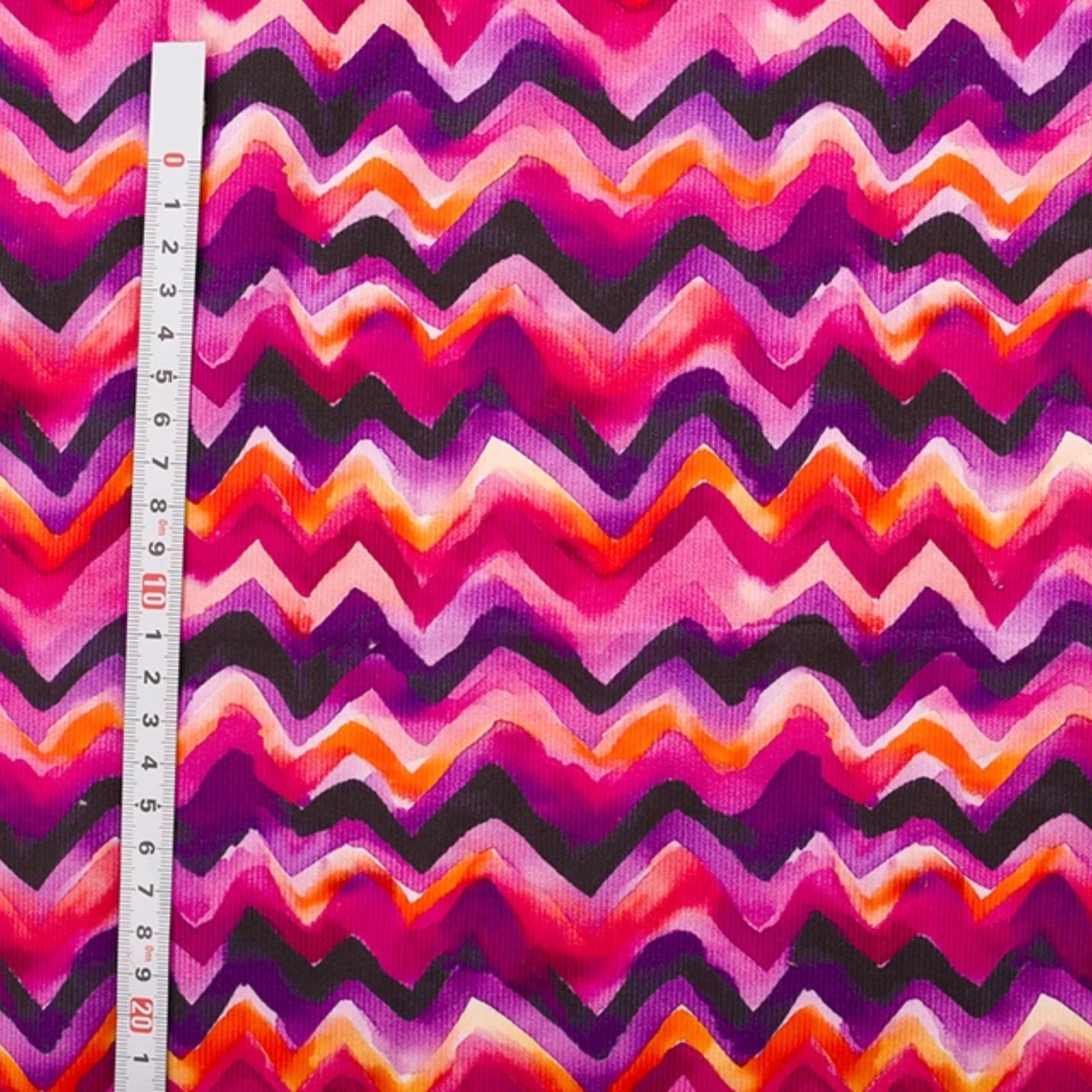 Needlecord fabric 100% cotton in zig zag print purple pinks 
