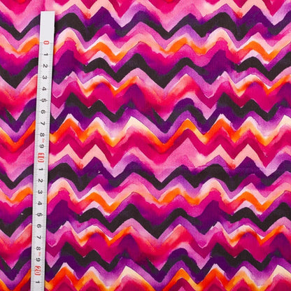 Needlecord fabric 100% cotton in zig zag print purple pinks 