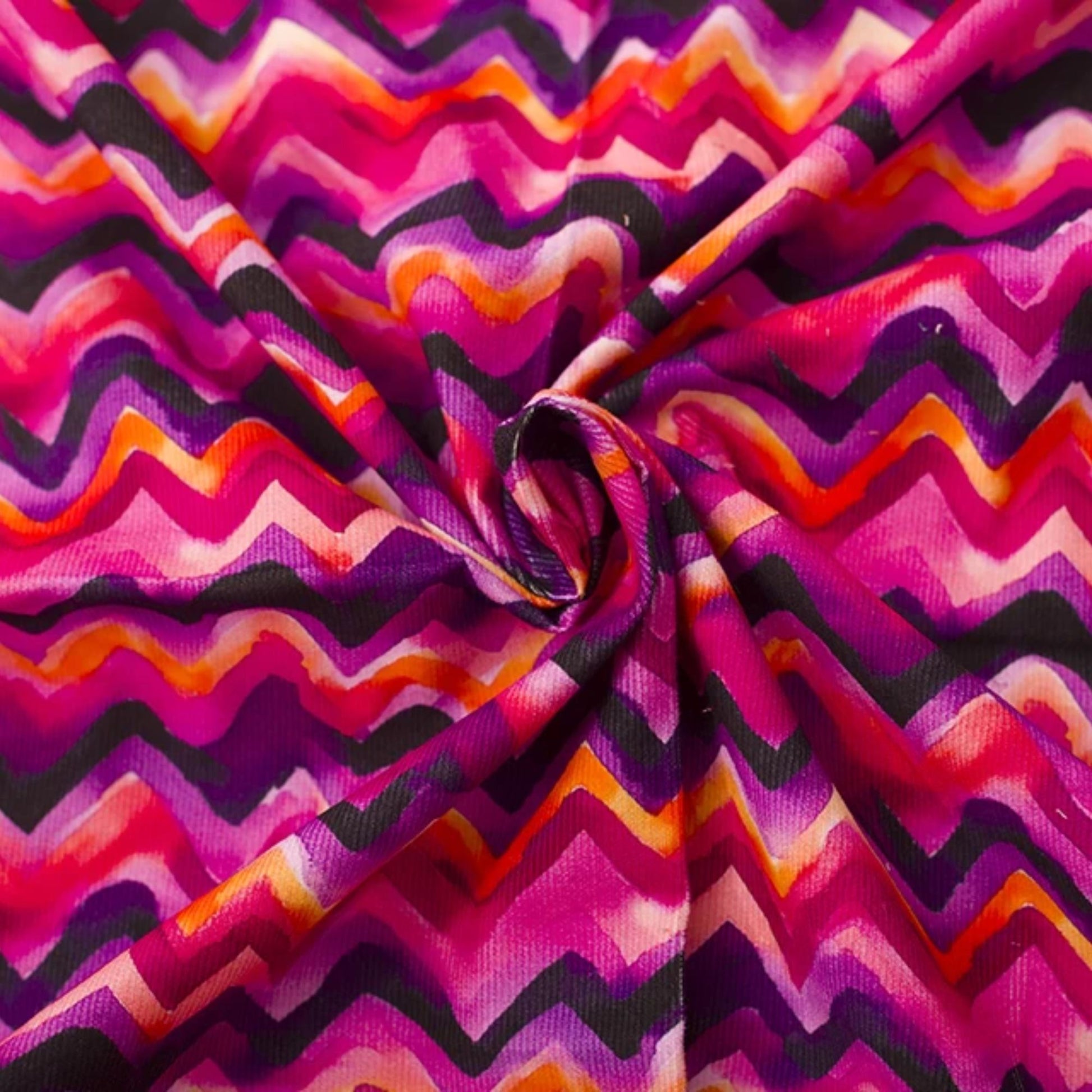 Needlecord fabric 100% cotton in zig zag print purple pinks 