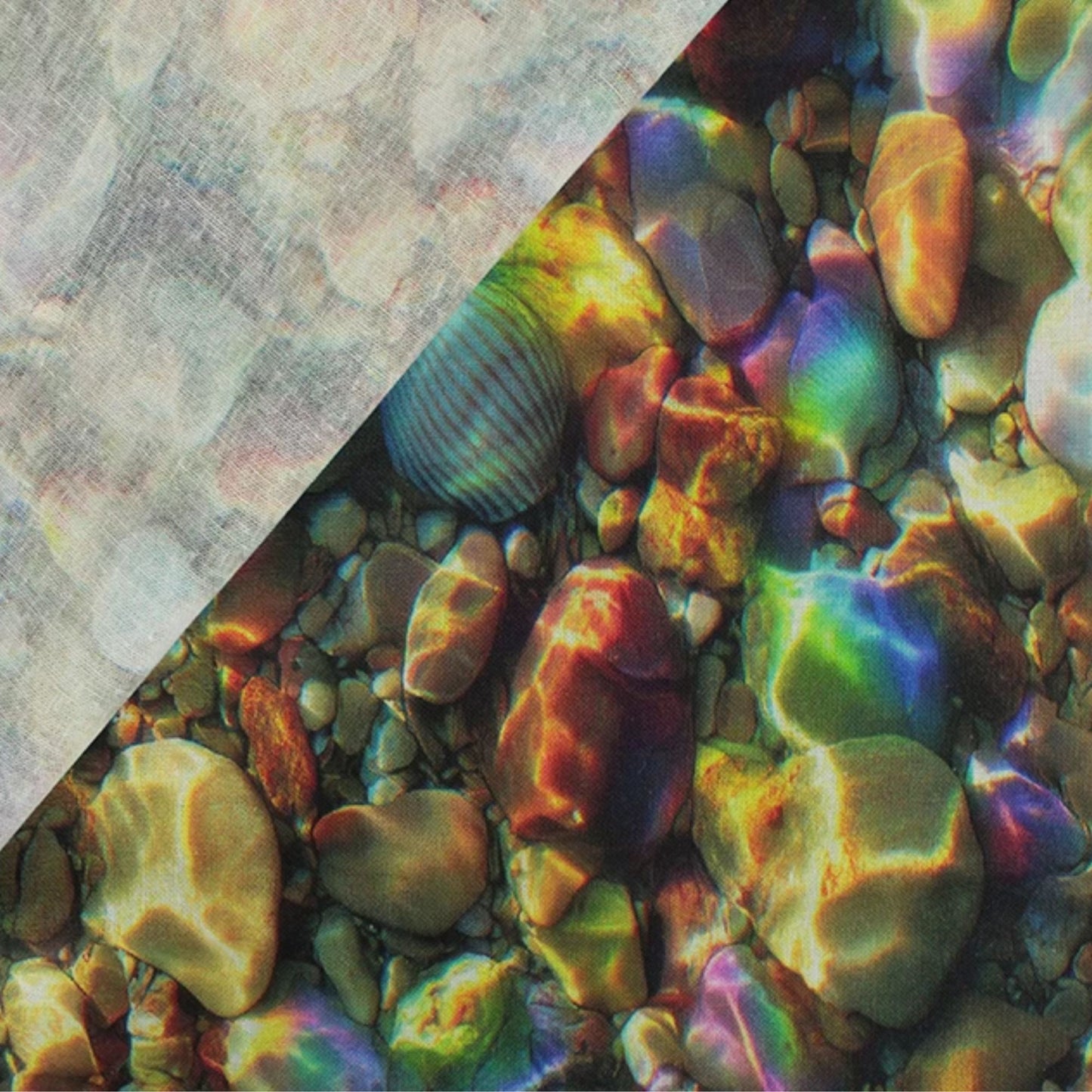 A close-up of a patterned fabric 100% cotton surface showing smooth stones and shells in shallow water, with strong iridescent rainbow reflections. A diagonal light gray textured section overlays the top left corner.